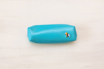 Blue pencil case with pony on white background