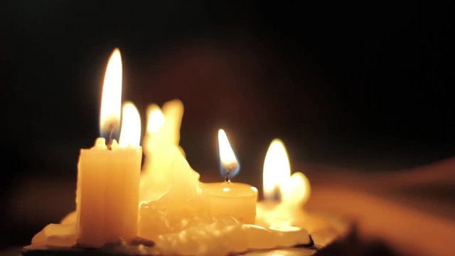 Close-up candle light. Man reading and Touching a Yellow Pages of old book