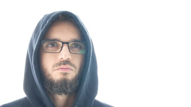 Close-up of bearded man in hoodie and eyeglasses shaking his head, studio isolated on white background.
