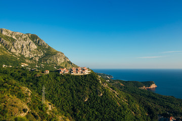 Russian village on the mountain in Montenegro over the island of Sveti Stefan.
