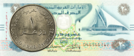 1 dirham coin against 20 united arab emirates dirham bank note obverse