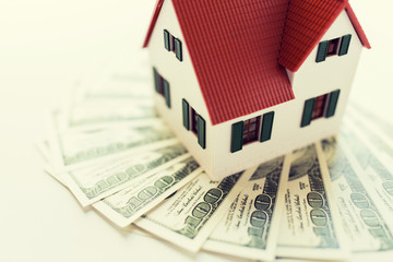 close up of home or house model and money