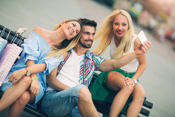 Three friends having fun on the bench