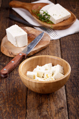Sliced fresh brined white cheese from cow milk