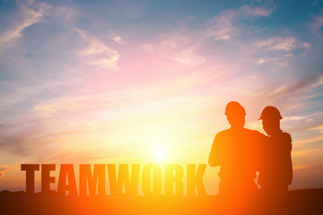 Fototapeta na wymiar Silhouette of two engineers in sunset, teamwork concept.
