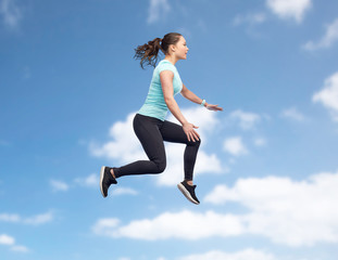 Fototapeta premium happy smiling sporty young woman jumping in air