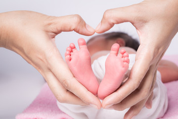 baby feet in mother hands,hearth shape