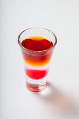 Fototapeta na wymiar Alcoholic cocktail in shot glass isolated on white