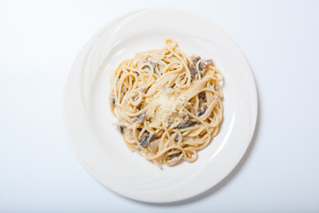 Italian pasta with mushrooms on a white plate