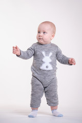 Baby boy shows to the left