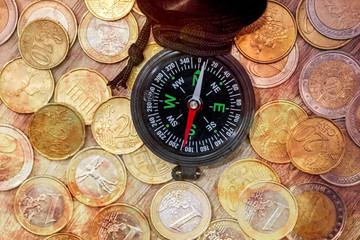 Financial concept  - compass with gold coin. close up.
