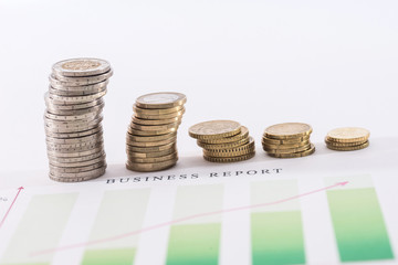 euro coin above business graph isolated on white