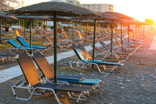 Empty sunbeds in a row on the pebble beach of Europe resirt hotel, Rhodes, Grrece