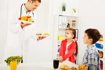 Pediatrician explaining children about healthy and unhealthy eating.