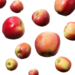 Falling red and yellow apples on white background isolated