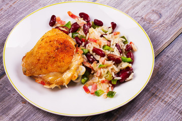 Chicken with Rice, Beans, Bacon and Green Pepper on White Plate