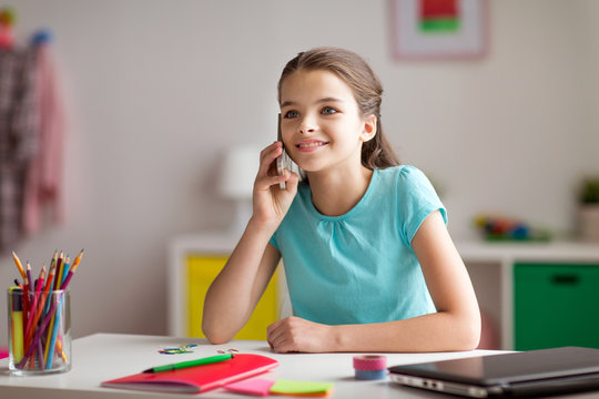 happy girl calling on smartphone at home