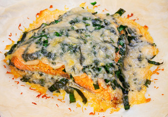 Obraz na płótnie Canvas Salmon with spinach and cheese. Baked fish on parchment