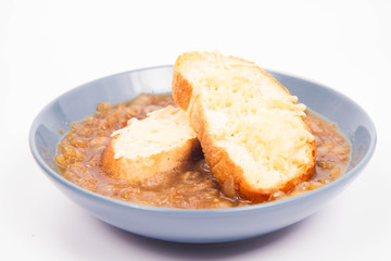 Onion soup with toast on a white background