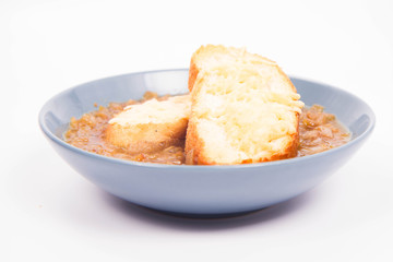 Onion soup with toast on a white background