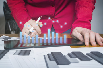 Business person analyzing financial statistics displayed on the smart phone screen. Financial planning concept.