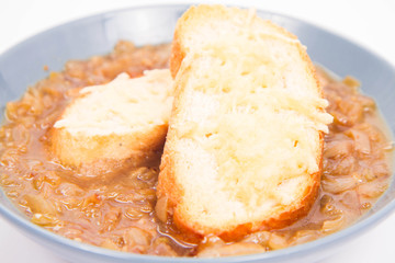 Onion soup with toast on a white background