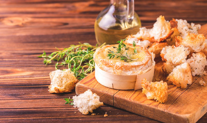 French baked Camembert cheese with thyme and baguette bread