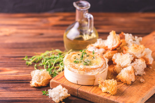 French baked Camembert cheese with thyme and baguette bread