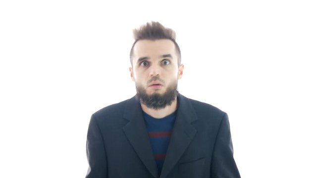 Crazy surprised bearded man in suit making funny faces and looking at you, hi-key studio isolated on white background.