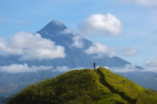 Hiker with backpack looks at the view on the Mayon volcano,Philippines