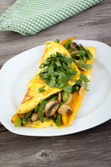 Stuffed vegetable omelet on wooden background