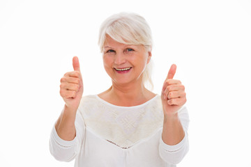 Senior woman showing thumbs up
