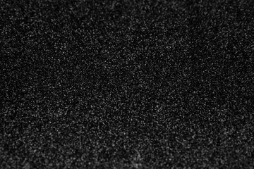 Black glitter background. Abstract shiny texture.