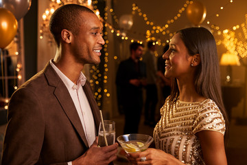 Couple Chat As They Enjoy Cocktail Party Together