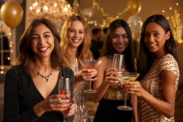 Female Friends Celebrating At Party Make Toast To Camera