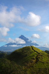 Hiker with backpack looks at the view on the Mayon volcano,Philippines