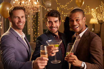 Male Friends Celebrating At Party Make Toast To Camera