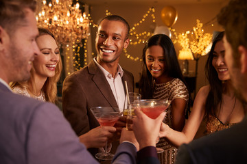 Group Of Friends With Drinks Enjoying Cocktail Party