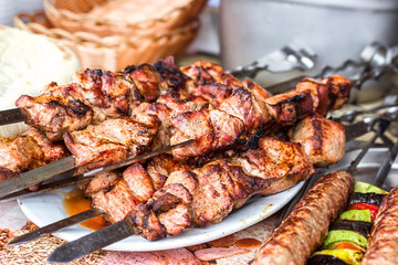 Marinated shashlik preparing on a barbecue grill over charcoal. Shashlik or Shish kebab popular in Eastern Europe. Shashlyk (skewered meat) was originally made of lamb. Roast Beef Kebabs On BBQ Grill.