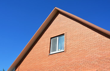 New Red  Brick House Construction. Brick house facade building. Attic Construction.