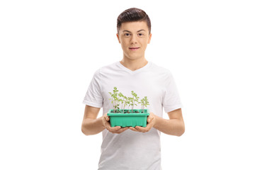 Teenager with a plant in a pot