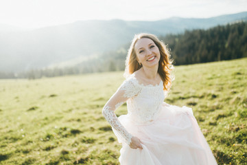 Fototapeta na wymiar Elegant bride at the mountains