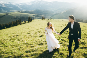 Beautiful bride and groom at the mountains