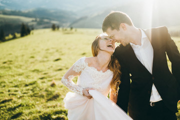 Beautiful bride and groom at the mountains