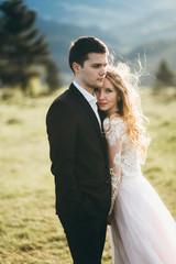 Beautiful bride and groom at the mountains
