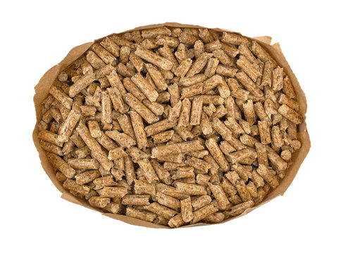 Top view of wood pellets in a brown paper bag isolated on a white background.