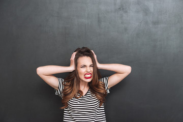 Young Screaming woman covering her ears