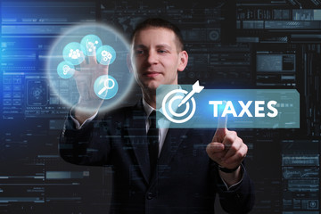 Business, Technology, Internet and network concept. Young businessman working on a virtual screen of the future and sees the inscription: Taxes