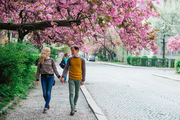 Couple walks in the spring city and t holds hands