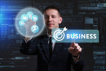 Business, Technology, Internet and network concept. Young businessman working on a virtual screen of the future and sees the inscription: Business